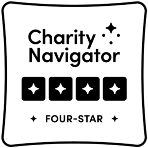 Charity Navigator Four-Star badge featuring four black stars and the words "Charity Navigator" and "FOUR-STAR" in bold black text with star icons.