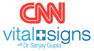 CNN logo above the text “vital signs with Dr. Sanjay Gupta,” featuring a medical cross symbol replacing the “a” in “vital,” styled in collaboration with ReSurge Press.