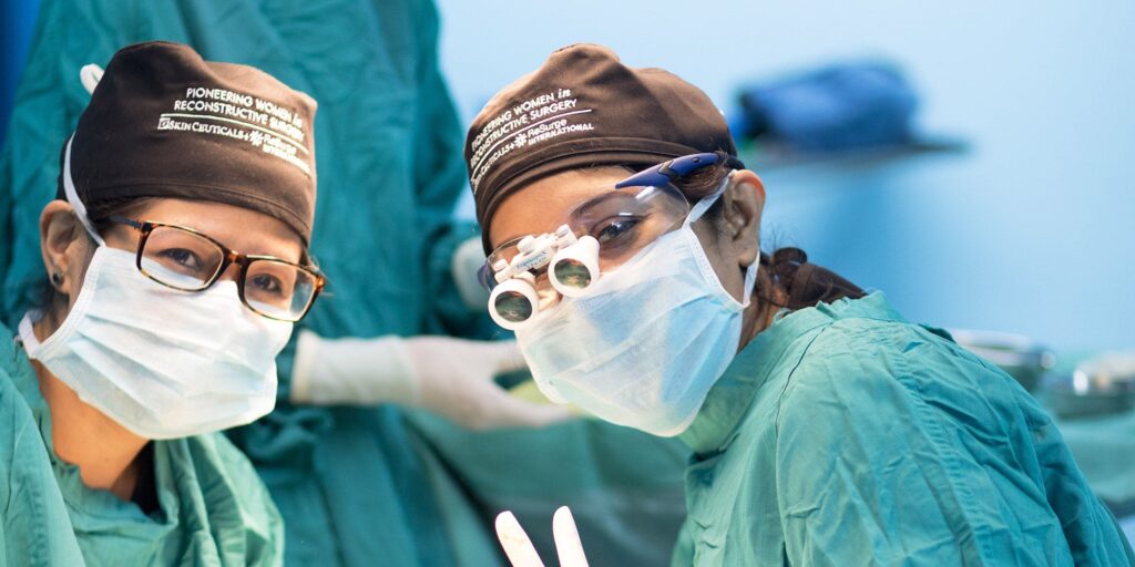 Women Surgeons wearing surgical masks and goggles