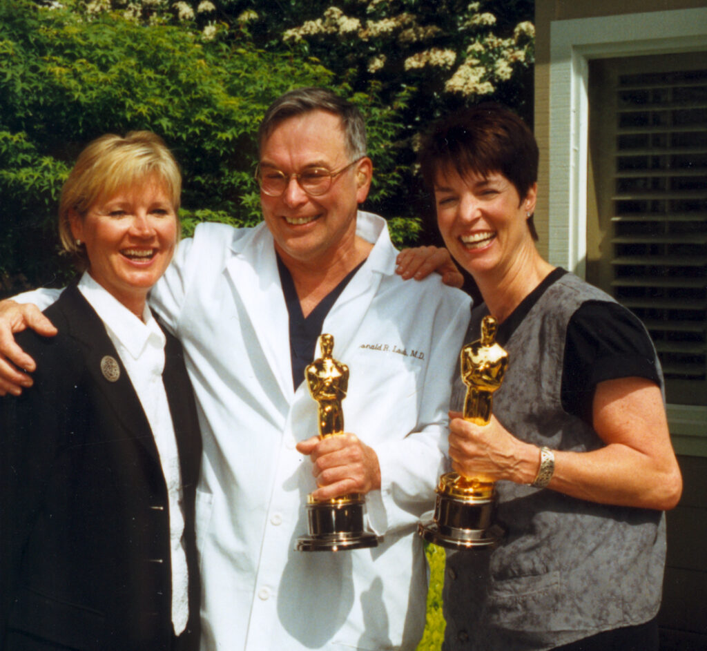 Dr. Donald Laub and the Interplast team holding awards as 'A Story of Healing' wins the Oscar for Best Documentary.