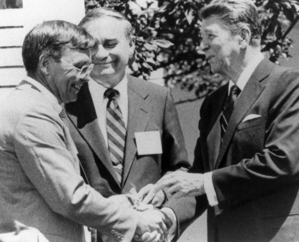Dr. Donald Laub and President Ronald Reagan shaking hands around 1980s