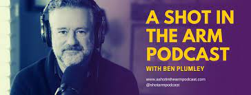 A man wearing headphones speaks into a microphone. Text beside him reads: "A Shot in the Arm Podcast with Ben Plumley"—exploring global surgical care—along with the podcast's website and social media handle.