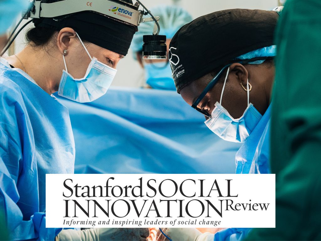 Two surgeons in blue scrubs and masks perform surgery in an operating room, highlighting the impact of training in medical excellence. The Stanford Social Innovation Review logo and tagline appear at the bottom of the image.